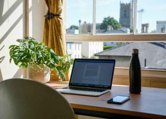 Laptop and work materials on a home desk
