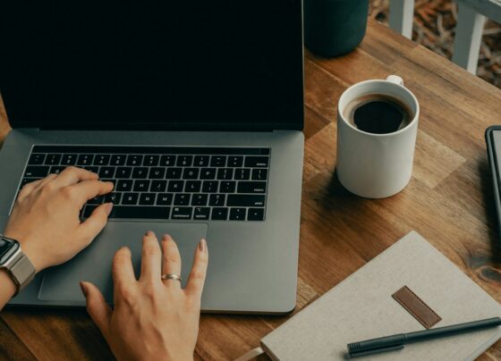 Laptop and notebook arranged on a home-office desk