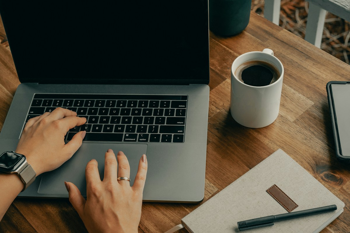 Laptop and notebook arranged on a home-office desk