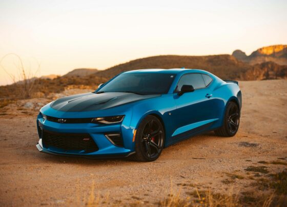 Blue Chevrolet sports car parked in a desert landscape