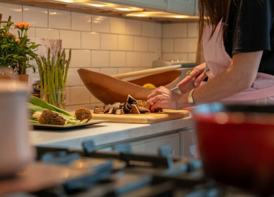 Person chopping vegetables on a kitchen cutting board
