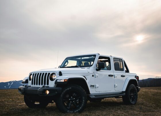 White Jeep Wrangler parked on rocky terrain