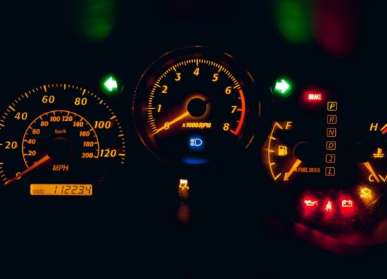 Illuminated car instrument cluster with an odometer and warning lights.
