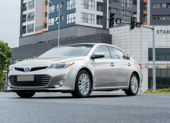 Silver Toyota sedan parked on a city street