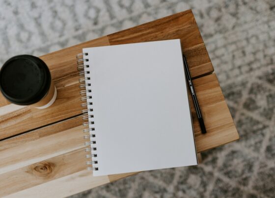 Open blank notebook with a pen