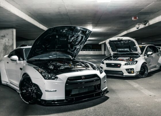 Cars with open hoods inside an automotive workshop