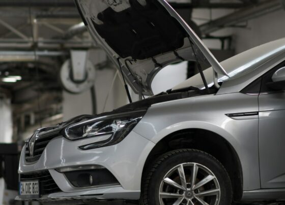 Cars being serviced on lifts in a workshop