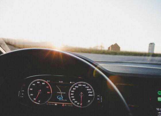 Dashboard viewed toward a road at sunset