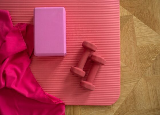 Exercise mat and small weights arranged for a home workout
